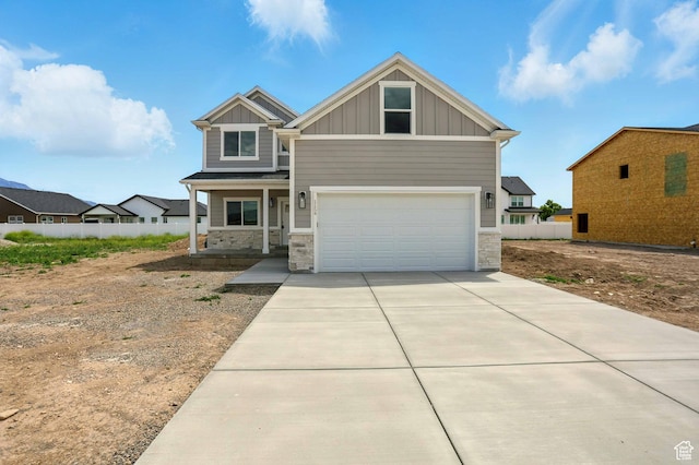 1154 E 1150 S, Garland, UT 84312 - craftsman house with board and batten siding, stone siding, driveway, an attached garage, and covered porch