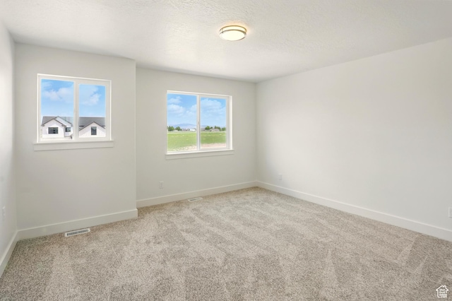1154 E 1150 S, Garland, UT 84312 - carpeted empty room featuring baseboards and a textured ceiling