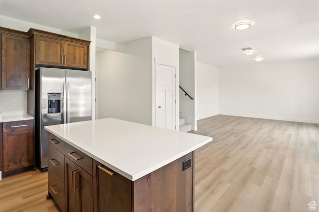 1154 E 1150 S, Garland, UT 84312 - kitchen with stainless steel fridge with ice dispenser, light wood-style flooring, light countertops, a kitchen island, and recessed lighting