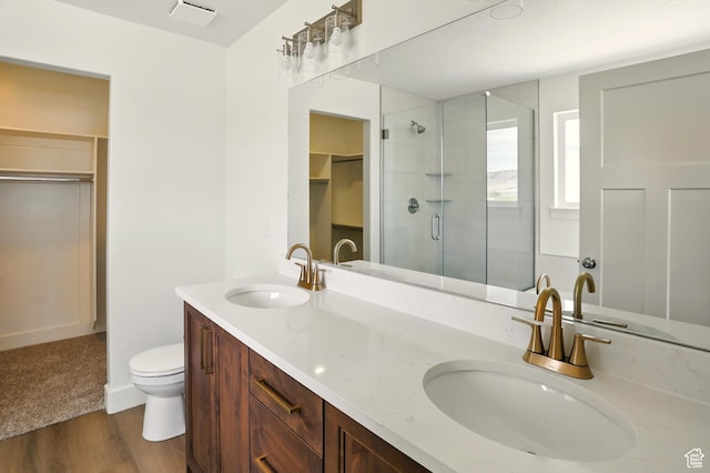 1154 E 1150 S, Garland, UT 84312 - full bath featuring a shower stall, a spacious closet, wood finished floors, and double vanity