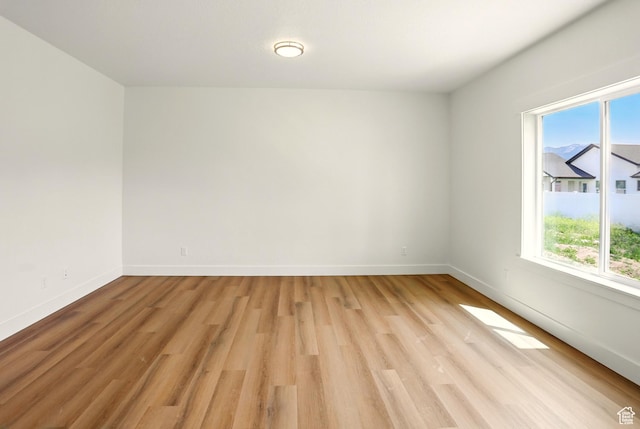 1154 E 1150 S, Garland, UT 84312 - empty room featuring plenty of natural light and light wood-style flooring