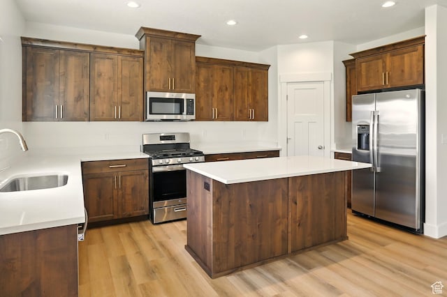 1154 E 1150 S, Garland, UT 84312 - kitchen featuring stainless steel appliances, light wood-style floors, a center island, recessed lighting, and light countertops