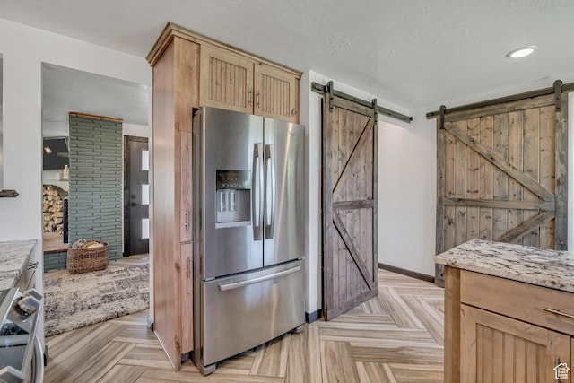 8695 E 800 S, Huntsville, UT 84317 - kitchen with stainless steel appliances, a barn door, light brown cabinetry, and recessed lighting
