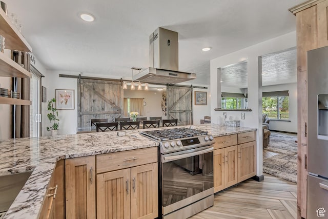 8695 E 800 S, Huntsville, UT 84317 - kitchen featuring stainless steel appliances, island exhaust hood, a barn door, light brown cabinets, and light stone countertops