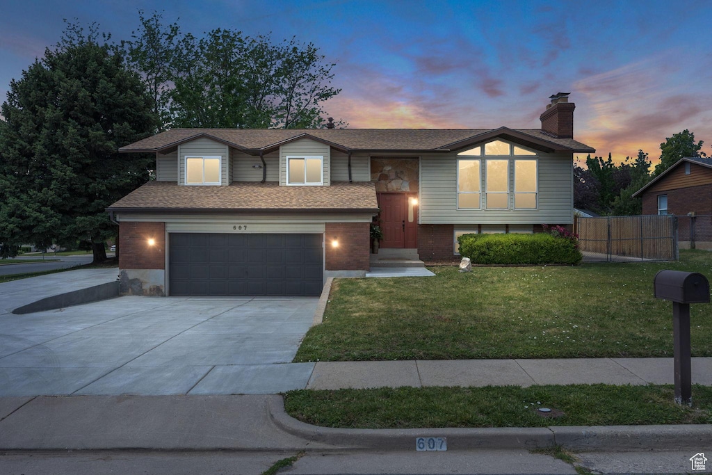607 S 300 E, Kaysville, UT 84037 - split foyer home with an attached garage, concrete driveway, and a chimney