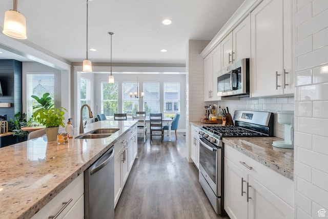 10616 S Wistful Way S, Jordan, UT 84009 - kitchen with stainless steel appliances, wood finished floors, recessed lighting, backsplash, and white cabinetry