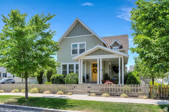 10616 S Wistful Way S, Jordan, UT 84009 - view of front of property with covered porch, board and batten siding, roof with shingles, a gate, and stucco siding