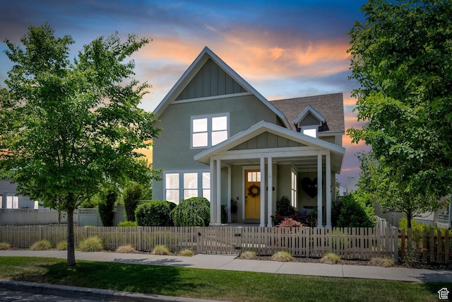 10616 S Wistful Way S, Jordan, UT 84009 - view of front of property featuring a porch, board and batten siding, a shingled roof, a fenced front yard, and a gate