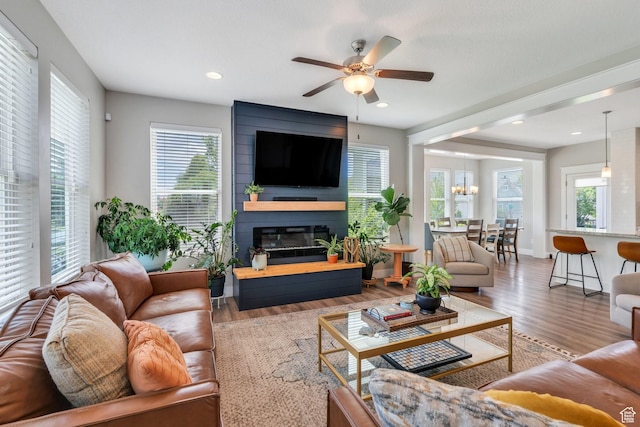 10616 S Wistful Way S, Jordan, UT 84009 - living room with plenty of natural light, a ceiling fan, wood finished floors, a fireplace, and recessed lighting