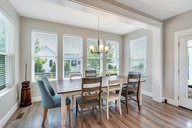 10616 S Wistful Way S, Jordan, UT 84009 - dining area featuring a chandelier, wood finished floors, and healthy amount of natural light