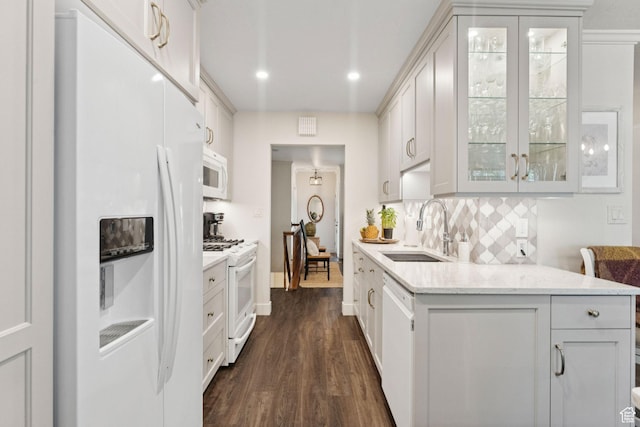 4178 S 650 E, Murray, UT 84107 - kitchen featuring white appliances, dark wood-style floors, glass insert cabinets, decorative backsplash, and light stone counters