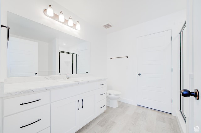 1858 N 515 W, Logan, UT 84341 - bathroom featuring vanity, wood finished floors, and an enclosed shower