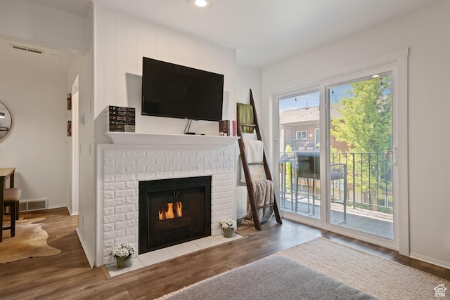 2402 S Elizabeth St Unit 5, Salt Lake City, UT 84106 - living area with wood finished floors, a brick fireplace, and recessed lighting