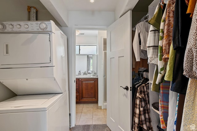 2402 S Elizabeth St Unit 5, Salt Lake City, UT 84106 - laundry area with estacked washer and dryer and light tile patterned floors