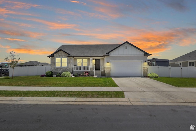 4764 N Gunsight Peak Dr, Eagle Mountain, UT 84005 - view of front of house with a garage, stone siding, driveway, a porch, and a gate