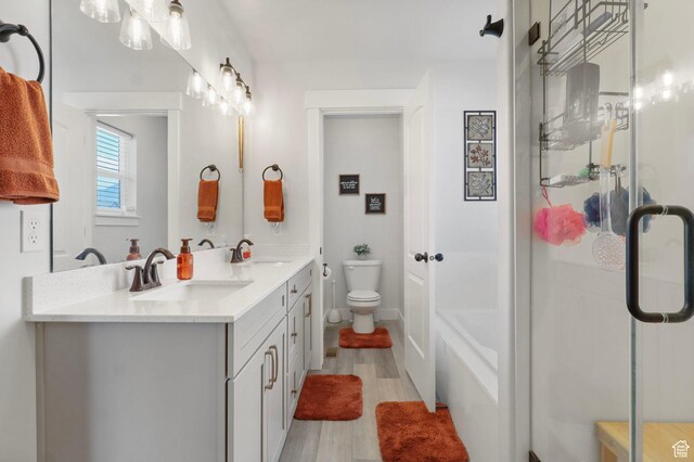 4764 N Gunsight Peak Dr, Eagle Mountain, UT 84005 - full bath with double vanity, a shower with door, wood finished floors, and a tub