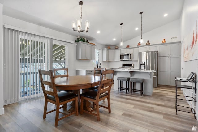 4764 N Gunsight Peak Dr, Eagle Mountain, UT 84005 - dining area featuring lofted ceiling, healthy amount of natural light, a chandelier, light wood-style flooring, and recessed lighting