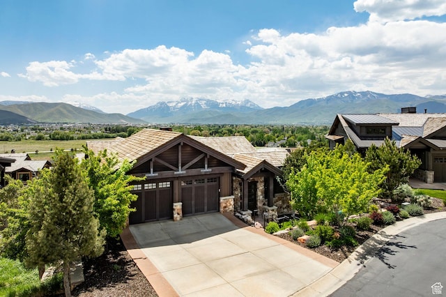 285 N Kings Peak Ct, Heber City, UT 84032 - view of front facade with a mountain view, a garage, stone siding, and concrete driveway