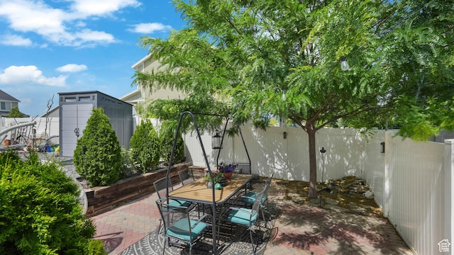 748 S Crooked Post Way, Saratoga Springs, UT 84045 - fenced backyard featuring a storage shed, a patio area, and outdoor dining area