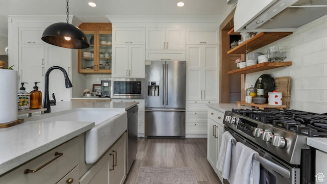 748 S Crooked Post Way, Saratoga Springs, UT 84045 - kitchen with stainless steel appliances, extractor fan, glass insert cabinets, decorative light fixtures, and light wood-style floors