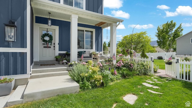 748 S Crooked Post Way, Saratoga Springs, UT 84045 - view of exterior entry featuring board and batten siding and a porch