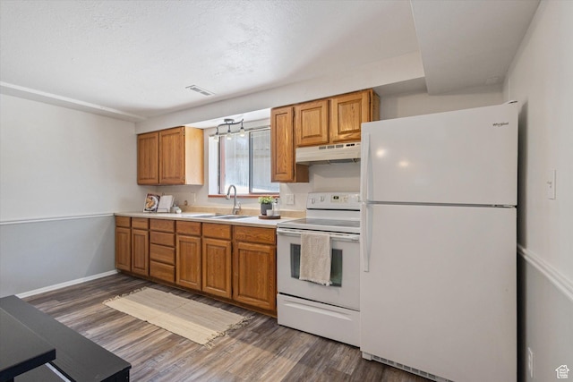 3195 E Willowcrest S, Cottonwood Heights, UT 84121 - kitchen with white appliances, under cabinet range hood, dark wood-type flooring, light countertops, and brown cabinets