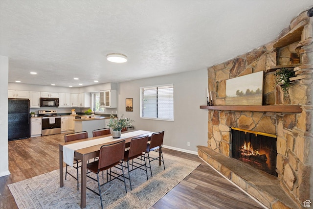 3195 E Willowcrest S, Cottonwood Heights, UT 84121 - dining room with wood finished floors, a fireplace, and recessed lighting