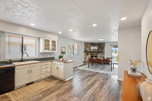 3195 E Willowcrest S, Cottonwood Heights, UT 84121 - kitchen featuring black dishwasher, a peninsula, dark wood-style flooring, glass insert cabinets, and recessed lighting