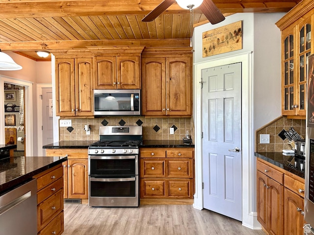 840 S Williams Cv W, Salem, UT 84653 - kitchen featuring appliances with stainless steel finishes, wood ceiling, ceiling fan, glass insert cabinets, and decorative backsplash