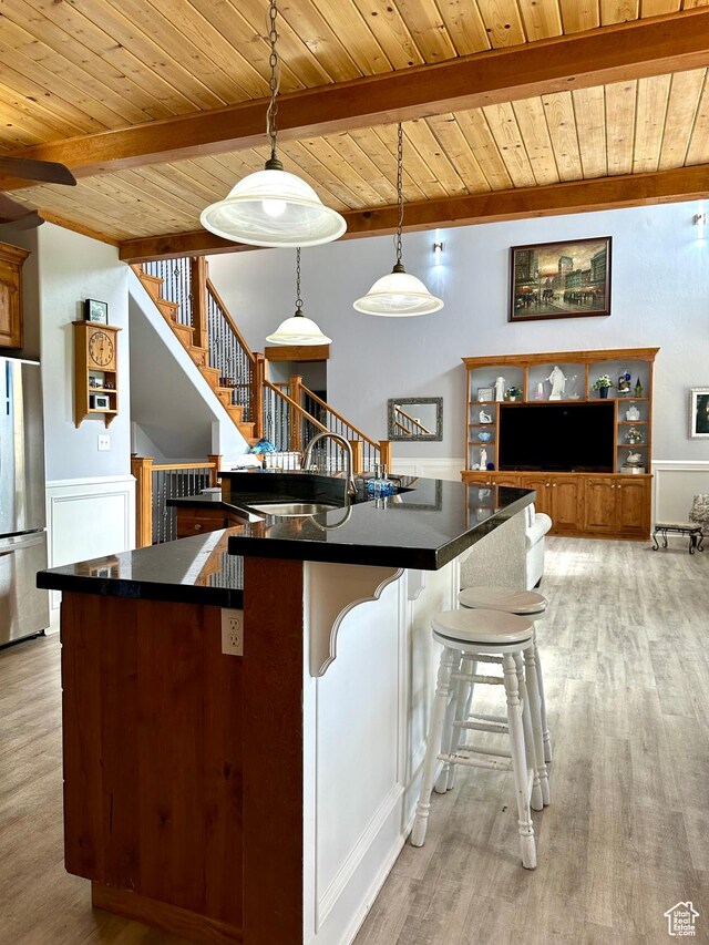 840 S Williams Cv W, Salem, UT 84653 - kitchen with freestanding refrigerator, a wood ceiling with exposed beams, dark countertops, and light wood-style flooring