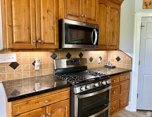 840 S Williams Cv W, Salem, UT 84653 - kitchen with appliances with stainless steel finishes and brown cabinetry