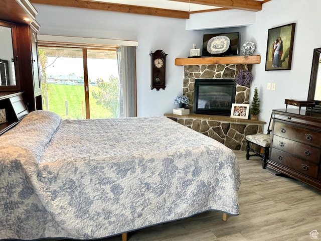 840 S Williams Cv W, Salem, UT 84653 - bedroom with wood finished floors, access to outside, a fireplace, and beamed ceiling