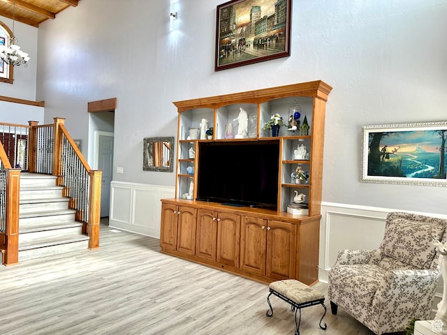 840 S Williams Cv W, Salem, UT 84653 - living area with light wood-style floors, a wood ceiling with exposed beams, stairs, a wainscoted wall, and a chandelier