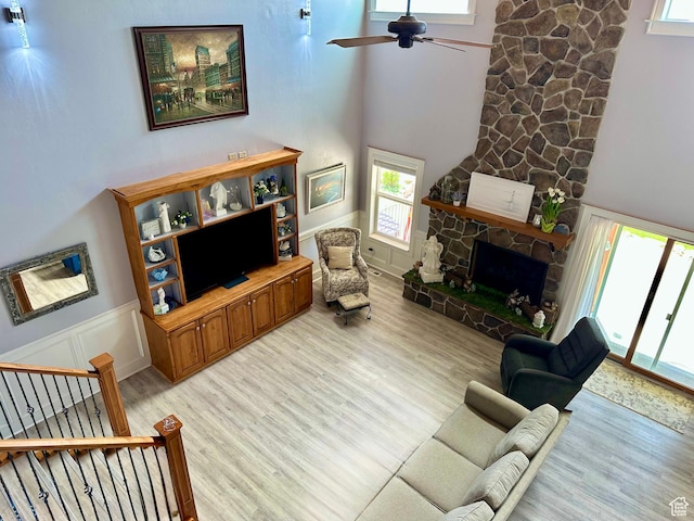 840 S Williams Cv W, Salem, UT 84653 - living room with light wood finished floors, plenty of natural light, a wainscoted wall, and a high ceiling
