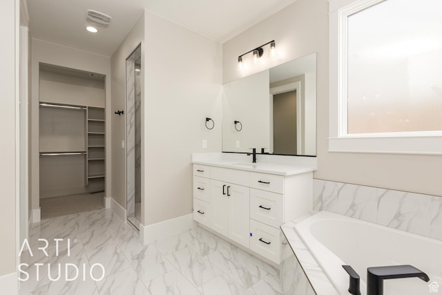 2818 E Rill Dr, Washington, UT 84780 - bathroom featuring a walk in closet, marble finish flooring, vanity, a bath, and a stall shower
