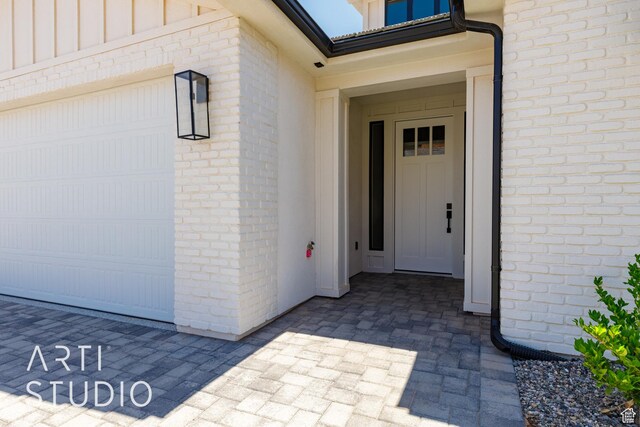 2818 E Rill Dr, Washington, UT 84780 - property entrance with board and batten siding, brick siding, and an attached garage
