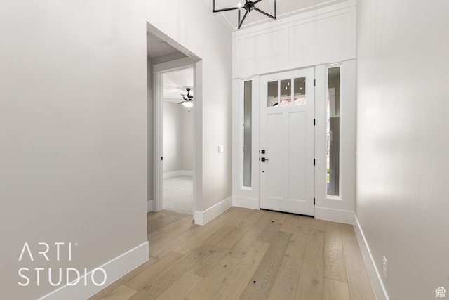 2818 E Rill Dr, Washington, UT 84780 - entryway with light wood-style floors, ceiling fan, and a chandelier