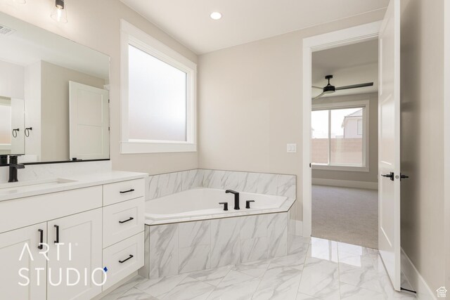 2818 E Rill Dr, Washington, UT 84780 - bathroom with vanity, a garden tub, marble finish floors, ceiling fan, and recessed lighting