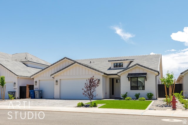 2818 E Rill Dr, Washington, UT 84780 - modern inspired farmhouse with brick siding, an attached garage, board and batten siding, and driveway