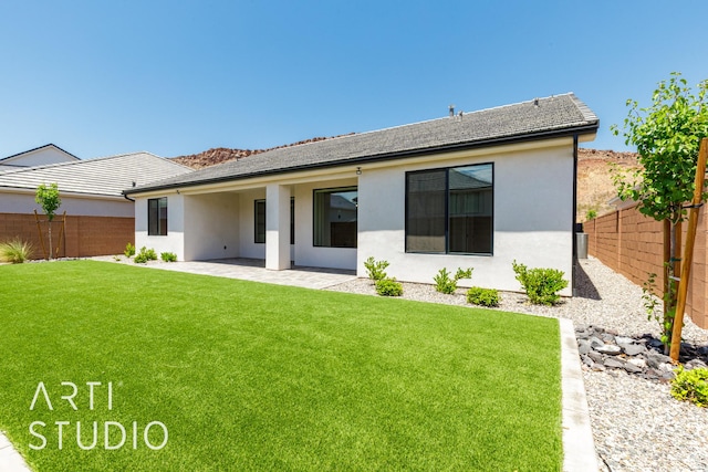 2818 E Rill Dr, Washington, UT 84780 - rear view of house featuring a fenced backyard, stucco siding, and a patio area