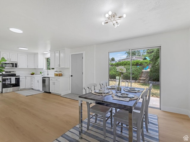 8359 S Fayeway Dr, Sandy, UT 84094 - dining area featuring light wood finished floors and baseboards
