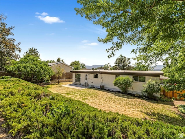8359 S Fayeway Dr, Sandy, UT 84094 - rear view of house featuring a fenced backyard, brick siding, a patio, and entry steps