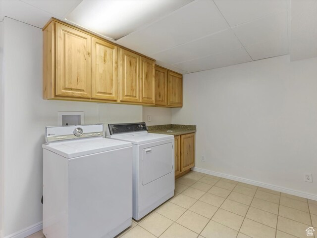 8359 S Fayeway Dr, Sandy, UT 84094 - laundry area featuring cabinet space, washing machine and clothes dryer, and light tile patterned floors
