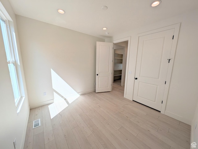 7071 W Granbury Dr S Unit 258, South Jordan, UT 84009 - unfurnished bedroom featuring recessed lighting and light wood-style flooring