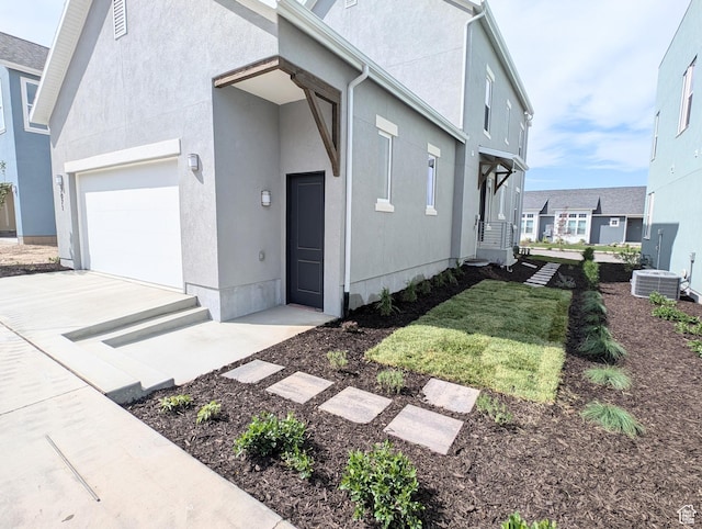 7071 W Granbury Dr S Unit 258, South Jordan, UT 84009 - view of side of property featuring a garage, stucco siding, and concrete driveway