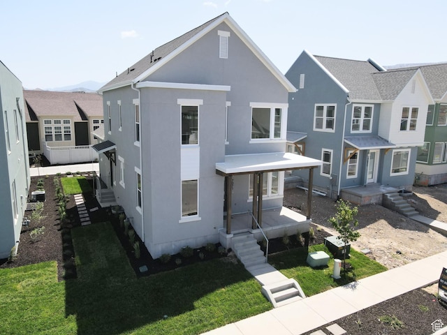 7071 W Granbury Dr S Unit 258, South Jordan, UT 84009 - view of front of property with stucco siding and a front yard