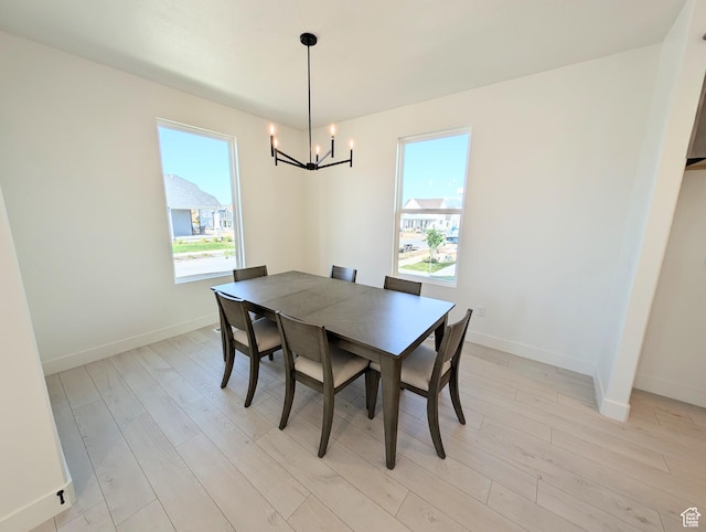 7071 W Granbury Dr S Unit 258, South Jordan, UT 84009 - dining space featuring a chandelier, light wood-style floors, and healthy amount of natural light