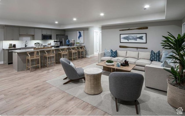 4578 N Solstice Dr Unit 332, Lehi, UT 84043 - living room with light wood-style flooring, recessed lighting, and a tray ceiling