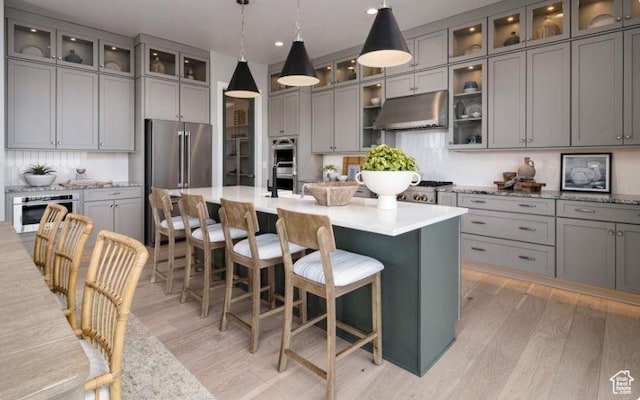 4578 N Solstice Dr Unit 332, Lehi, UT 84043 - kitchen with under cabinet range hood, gray cabinets, stainless steel appliances, light wood-style flooring, and recessed lighting