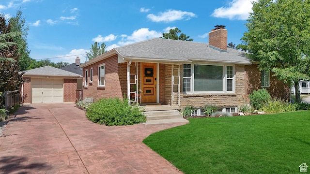 2612 S 1900 E, Salt Lake City, UT 84106 - view of front of house with a chimney, a front yard, brick siding, concrete driveway, and an outdoor structure
